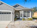 House entrance with double doors and a bay window at 4327 Canongate Ct, Spring Hill, FL 34609