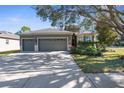 House exterior showcasing a two-car garage and landscaping at 4446 Marsalis Ct, Spring Hill, FL 34609