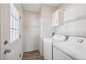 Bright laundry room with washer, dryer, and ample shelving at 4620 Tri Par Dr, Sarasota, FL 34234