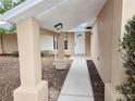 Covered entryway with walkway leading to front door at 7651 Vienna Ln, Port Richey, FL 34668