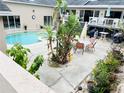 Inviting pool area with patio furniture and lush landscaping at 7941 Sycamore Dr, New Port Richey, FL 34654