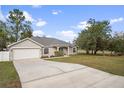 Well maintained single-story home with an attached garage and long driveway at 12499 Convent Garden Rd, Brooksville, FL 34613