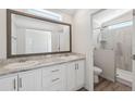 Bathroom with double vanity, large mirror, and a walk-in shower at 1852 Cypress Point Ln, Sarasota, FL 34234