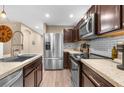 Modern kitchen with stainless steel appliances and granite countertops at 26416 Mcallister St, Brooksville, FL 34602