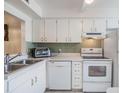 Efficient kitchen featuring white cabinetry and modern appliances at 3644 Trophy Blvd, New Port Richey, FL 34655