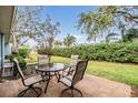 Relaxing patio with table and chairs, surrounded by lush greenery at 3644 Trophy Blvd, New Port Richey, FL 34655