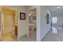 Hallway view showcasing access to bathroom, bedroom, and living area, all featuring neutral color palettes and modern design at 4148 Sand Ridge Blvd, Spring Hill, FL 34609