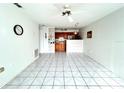 Open kitchen with wood cabinets and a breakfast bar at 4375 Tahitian Gardens Cir # B, Holiday, FL 34691