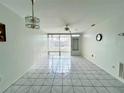 Spacious living room with tile floors and sliding glass doors at 4375 Tahitian Gardens Cir # B, Holiday, FL 34691