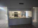 Kitchen features granite countertops and stainless steel appliances at 12804 Waterbury Ave, Hudson, FL 34669