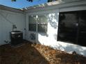 Rear exterior view showcasing AC unit and shed at 4392 Craftsbury Dr, New Port Richey, FL 34652
