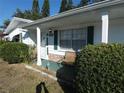 Front porch entry with green shutters and a bench at 4392 Craftsbury Dr, New Port Richey, FL 34652