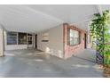 Covered carport area with a concrete floor, brick walls, and vine accents at 4939 18Th St, Zephyrhills, FL 33542