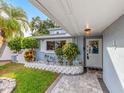 Inviting front door with decorative glass, flanked by tropical landscaping at 5137 Blue Heron Dr, New Port Richey, FL 34652