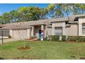 Well-maintained home with a grassy yard, landscaped shrubbery, and a snowman decoration at 7423 Woodhollow Rd, Spring Hill, FL 34606