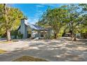 Charming single-story home with a spacious driveway, mature trees, and a cozy front porch at 7600 138Th St, Seminole, FL 33776