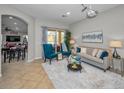 Comfortable living room with stylish furniture, a neutral color palette, and sliding doors to the outdoor space at 11645 Belle Haven Dr, New Port Richey, FL 34654