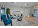 Living room with blue accent chairs, a neutral sofa, and a large area rug at 11645 Belle Haven Dr, New Port Richey, FL 34654