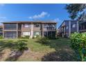 Rear view of condo showing patio and lawn at 12814 Wedgewood Way # C, Hudson, FL 34667