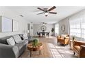 Inviting living room with modern furnishings, wood-look flooring, and ceiling fans at 2118 Huntington Ave, Sarasota, FL 34232