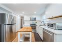 Bright kitchen featuring white cabinets, stainless steel appliances, and butcher block island at 3444 Clydesdale Dr, Holiday, FL 34691