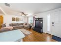 Open and spacious living room with comfortable seating, stylish rug, and wooden floors at 3444 Clydesdale Dr, Holiday, FL 34691