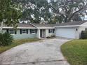 Charming light green house with a two-car garage at 3606 River Grove Dr, Tampa, FL 33610