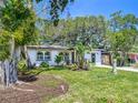 White home with new windows, landscaping, and mature trees at 4629 26Th S Ave, St Petersburg, FL 33711