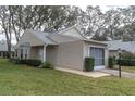 Well maintained single story home exterior showing front door and side entry garage at 4846 Leyte Ct, New Port Richey, FL 34655
