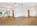 Spacious living area with hardwood floors and ceiling fan at 6288 Airmont Dr, Spring Hill, FL 34606