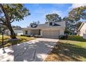 Inviting home with a decorative driveway, landscaping, and attached garage at 6409 Wedgewood Dr, Spring Hill, FL 34606