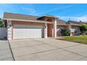 Front exterior view of a single-story home with attached garage and driveway at 714 Charlotte Ave, Tarpon Springs, FL 34689