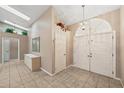 Foyer with tiled flooring, double doors, skylights, and storage at 714 Charlotte Ave, Tarpon Springs, FL 34689