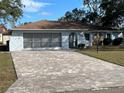 Ranch-style home with paved driveway and mature landscaping at 11556 Linden Dr, Spring Hill, FL 34608