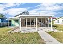 Ranch style home with covered patio and walkway at 13816 Coco Ave, Hudson, FL 34667