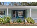 Inviting front porch with blue details and comfortable seating at 2695 Royal Ridge Dr, Spring Hill, FL 34606