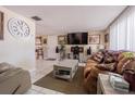 Living room with brown couch, coffee table, and large TV at 3049 Moog Rd, Holiday, FL 34691