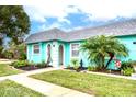 Cute teal home with a lush green lawn at 4209 Prince Pl # A, New Port Richey, FL 34652