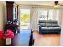 Bright living room featuring hardwood floors, a gray sofa, and a large antique cabinet at 5945 21St N St # 2, St Petersburg, FL 33714