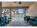 Inviting screened porch with comfortable seating overlooking a sparkling pool at 692 Challice Dr, Spring Hill, FL 34609