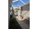 Screened entryway with a bench and small garden at 7221 Cleopatra Dr, Land O Lakes, FL 34637