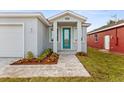 New home with a teal front door and paver walkway at 8290 40Th N St, Pinellas Park, FL 33781
