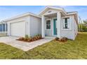 New home featuring a teal front door and paver driveway at 8290 40Th N St, Pinellas Park, FL 33781