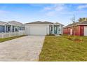 New construction home with teal front door and paver driveway at 8290 40Th N St, Pinellas Park, FL 33781