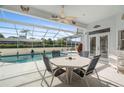Enjoy dining alfresco in this screened pool area at 8540 Caitlin Ct, Hudson, FL 34667