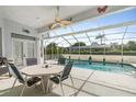 Relaxing patio with table and chairs overlooking the pool at 8540 Caitlin Ct, Hudson, FL 34667