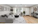Bright and airy living room with wood-look floors at 9240 Whitman Ln, Port Richey, FL 34668