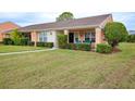 Front view of a single-story house with a covered porch and well-manicured lawn at 9327 Whitstone Ct, New Port Richey, FL 34655
