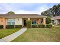 Front view of a light peach house with a covered porch and walkway at 9327 Whitstone Ct, New Port Richey, FL 34655