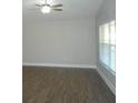 Bright living room with neutral walls and wood-look flooring at 9520 Highland Ridge Dr, Hudson, FL 34667